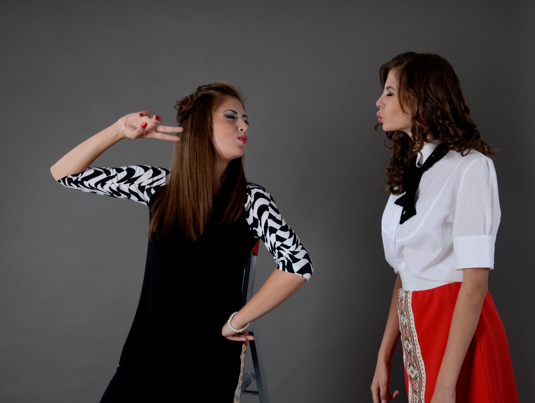 Two young women posing playfully in a fashion photoshoot. — Essential Guide to Downloading Atomic Wallet