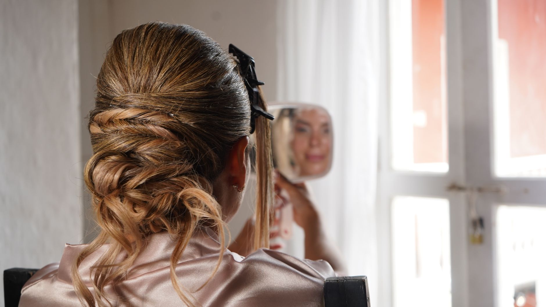 Elegant updo hairstyle reflection in mirror, showcasing a bridal or formal style indoors. — How Bscscan Revolutionizes Blockc